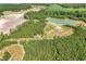 Stunning aerial view of acreage featuring a pond, barn and tree-lined property at 7299 Cartrette Rd., Aynor, SC 29511