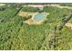 Scenic aerial view showcasing the expansive property with a picturesque lake at 7299 Cartrette Rd., Aynor, SC 29511