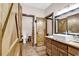 Bathroom with rustic wood vanity, vessel sink, and wood barn door to toilet room at 7299 Cartrette Rd., Aynor, SC 29511