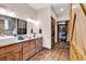 The primary bathroom boasts wooden cabinets, double sinks, mirrors, and a walk-in closet at 7299 Cartrette Rd., Aynor, SC 29511
