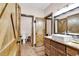 Bathroom featuring rustic wood doors, tile flooring, and marble countertops with an elegant sink at 7299 Cartrette Rd., Aynor, SC 29511