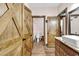 Bathroom featuring double doors, single vanity with granite countertop, and wood-look tile floor at 7299 Cartrette Rd., Aynor, SC 29511