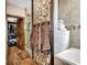Beautiful bathroom featuring stone accent wall, soaking tub, glass shower, and wood-look tile floors at 7299 Cartrette Rd., Aynor, SC 29511
