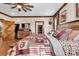 Cozy bedroom with wood accents, including a decorative ceiling fan and wooden furniture at 7299 Cartrette Rd., Aynor, SC 29511