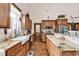 Spacious kitchen with wood cabinets, farmhouse sink, and a large island with marble countertops at 7299 Cartrette Rd., Aynor, SC 29511