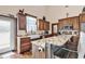 Stylish kitchen features granite countertops, wood cabinets, and a farm-style sink at 7299 Cartrette Rd., Aynor, SC 29511