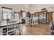 Farmhouse kitchen featuring wood cabinets, an island with bar stools, and a dining area at 7299 Cartrette Rd., Aynor, SC 29511