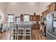 An open kitchen and breakfast bar with wooden cabinets, stainless appliances, and pendant lighting at 7299 Cartrette Rd., Aynor, SC 29511