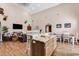Spacious living room featuring island with granite countertop, with wood floors, and vaulted ceilings at 7299 Cartrette Rd., Aynor, SC 29511