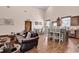 Spacious living room featuring wood floors, high ceilings, sofa, island, and a dining area at 7299 Cartrette Rd., Aynor, SC 29511
