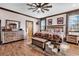 Inviting primary bedroom featuring wood floors, a cozy bed with rustic decor, and natural light at 7299 Cartrette Rd., Aynor, SC 29511