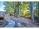 A backyard view of the wooded lot featuring a walkway to wooden deck attached to house and a line of trees at 121 Grand Palm Ct., Myrtle Beach, SC 29579