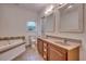 Bathroom featuring double sinks, a soaking tub, tiled floors, and natural light at 121 Grand Palm Ct., Myrtle Beach, SC 29579