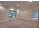Spacious carpeted bedroom with a large window bringing in natural light at 121 Grand Palm Ct., Myrtle Beach, SC 29579