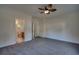 Comfortable bedroom offering neutral carpeting, a ceiling fan, and an ensuite bathroom entrance at 121 Grand Palm Ct., Myrtle Beach, SC 29579