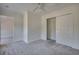 Bright bedroom featuring plush grey carpet, fresh paint, a ceiling fan, and a closet with sliding doors at 121 Grand Palm Ct., Myrtle Beach, SC 29579