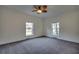 Spacious bedroom featuring neutral carpeting, dual windows, and a modern ceiling fan for comfort at 121 Grand Palm Ct., Myrtle Beach, SC 29579