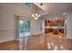 Dining area with hardwood floors, chandelier and access to a modern kitchen and outdoor area at 121 Grand Palm Ct., Myrtle Beach, SC 29579