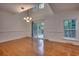 Open dining area with hardwood floors, a modern chandelier, and sliding glass doors at 121 Grand Palm Ct., Myrtle Beach, SC 29579