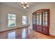 Bright dining room with wood floors, large windows, and a china cabinet, perfect for entertaining at 121 Grand Palm Ct., Myrtle Beach, SC 29579