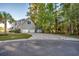 Exterior view of home featuring a long driveway, two-car garage, and a view of the house from the side at 121 Grand Palm Ct., Myrtle Beach, SC 29579