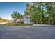 Exterior view of home featuring a long driveway, two-car garage, palm trees and a side view of the house at 121 Grand Palm Ct., Myrtle Beach, SC 29579