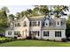 Beautiful two-story home with white siding, black shutters, manicured lawn and an American flag at 121 Grand Palm Ct., Myrtle Beach, SC 29579