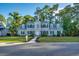 Charming two-story home featuring a well-manicured lawn, a paved walkway, and black shutters at 121 Grand Palm Ct., Myrtle Beach, SC 29579
