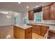 Open kitchen featuring an island, modern appliances, wood floors, and views into the breakfast area at 121 Grand Palm Ct., Myrtle Beach, SC 29579
