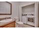 Combined bathroom and laundry room offers convenience with modern washer and dryer in closet at 121 Grand Palm Ct., Myrtle Beach, SC 29579