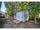 A backyard view of the home's outdoor shed featuring wooden access ramp, light gray siding and white trim at 121 Grand Palm Ct., Myrtle Beach, SC 29579