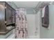 Bathroom with shower, storage cabinet, and rod for hanging towels at 133 Junco Circle, Longs, SC 29568