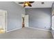 Carpeted bedroom with a ceiling fan and natural light at 133 Junco Circle, Longs, SC 29568