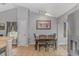 Bright dining area adjacent to kitchen featuring tile floors, modern lighting, and ample seating space at 133 Junco Circle, Longs, SC 29568