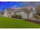 Charming single-story home featuring a two-car garage, well-manicured lawn, and beautiful landscaping at 133 Junco Circle, Longs, SC 29568