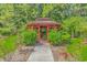 Landscaped gazebo area with mature landscaping at 133 Junco Circle, Longs, SC 29568