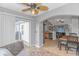 Bright living room featuring tile floors, ceiling fan, and sliding glass door to the exterior at 133 Junco Circle, Longs, SC 29568