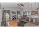 Bright and cozy living room with hardwood floors and access to the dining area and kitchen at 133 Junco Circle, Longs, SC 29568