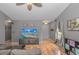 Cozy living room with wood floors, a ceiling fan, and a large TV at 133 Junco Circle, Longs, SC 29568