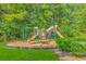 Outdoor playground with swings, slides, and a wood chip safety base at 133 Junco Circle, Longs, SC 29568