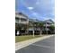 Two-story condo building with parking and landscaping at 5801 Oyster Catcher Dr. # 124, North Myrtle Beach, SC 29582