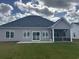 Well-maintained backyard featuring a patio, sliding glass doors, and a screened-in porch at 2327 King Farm Rd., Aynor, SC 29511