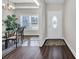 Bright entryway featuring wood-look flooring, decorative rug, and a white door, creating an inviting and stylish entrance at 2327 King Farm Rd., Aynor, SC 29511