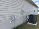 Side view of a home showcasing HVAC system, electrical boxes, and utility connections at 2327 King Farm Rd., Aynor, SC 29511