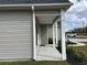 A view of the covered front porch, showcasing its inviting entrance and manicured landscaping at 2327 King Farm Rd., Aynor, SC 29511