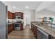 Well-lit kitchen featuring stainless steel appliances, granite counters, and dark cabinetry, offering a modern and functional cooking space at 2327 King Farm Rd., Aynor, SC 29511