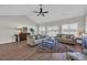 Spacious living room with vaulted ceilings, hardwood floors, neutral furniture, and large windows providing plenty of natural light at 2327 King Farm Rd., Aynor, SC 29511