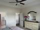 Bright main bedroom with neutral walls, ceiling fan and views into the bathroom and closet at 2327 King Farm Rd., Aynor, SC 29511