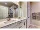 Bathroom with double sinks, a large mirror, and a tiled shower with glass door at 2557 7B Pete Dye Dr. # 704, North Myrtle Beach, SC 29582