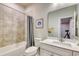 Full bathroom with tub, shower, and white vanity with a framed art piece at 2557 7B Pete Dye Dr. # 704, North Myrtle Beach, SC 29582